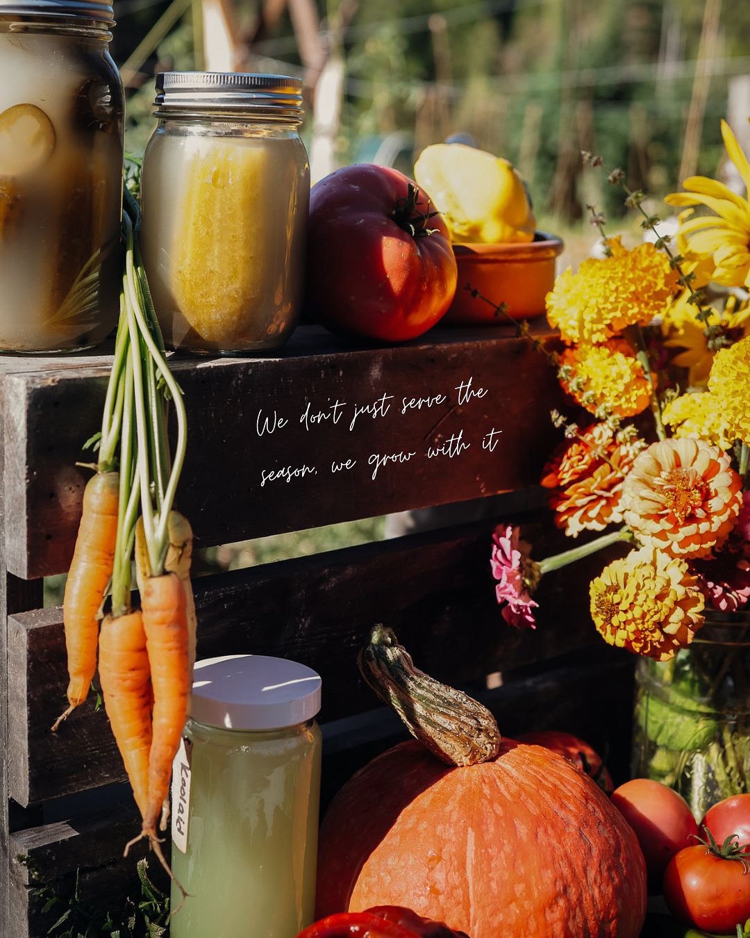 An autumn harvest of squash, carrots, preserves and flowers at the farm