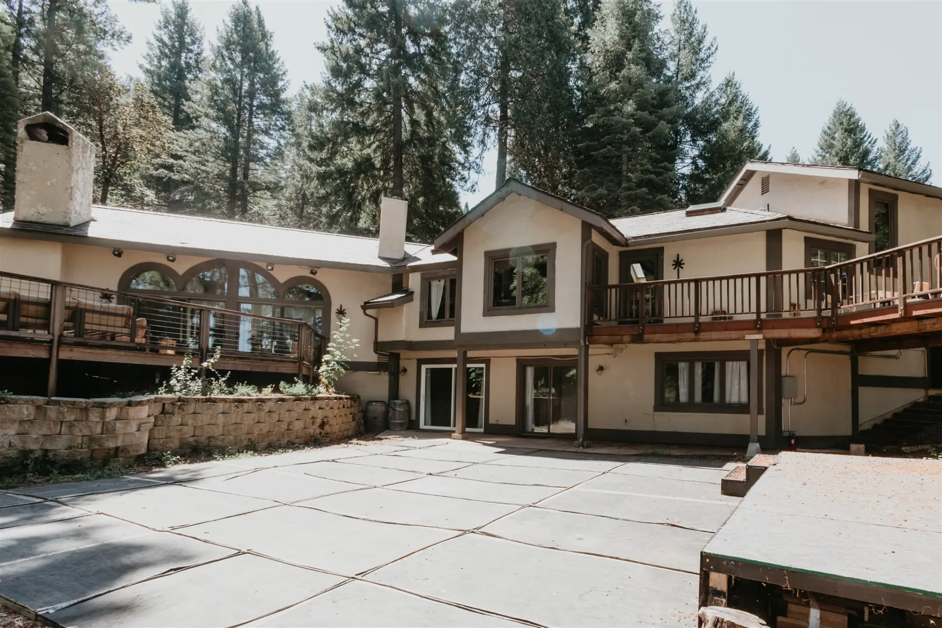 The lodge seen from the courtyard, its balconies and arched windows set against the pines
