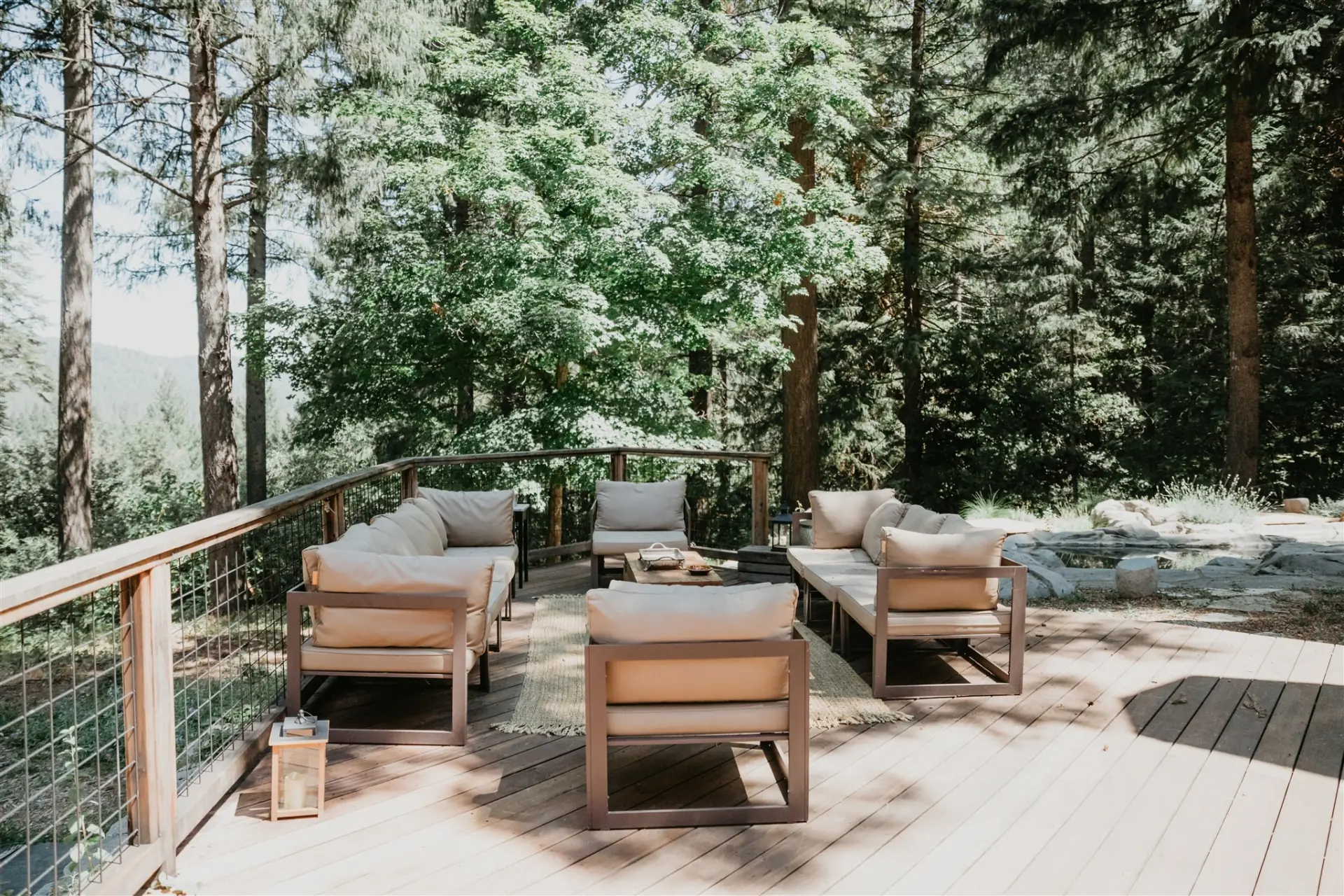 Lounge seating on the deck, looking out into the forest canopy