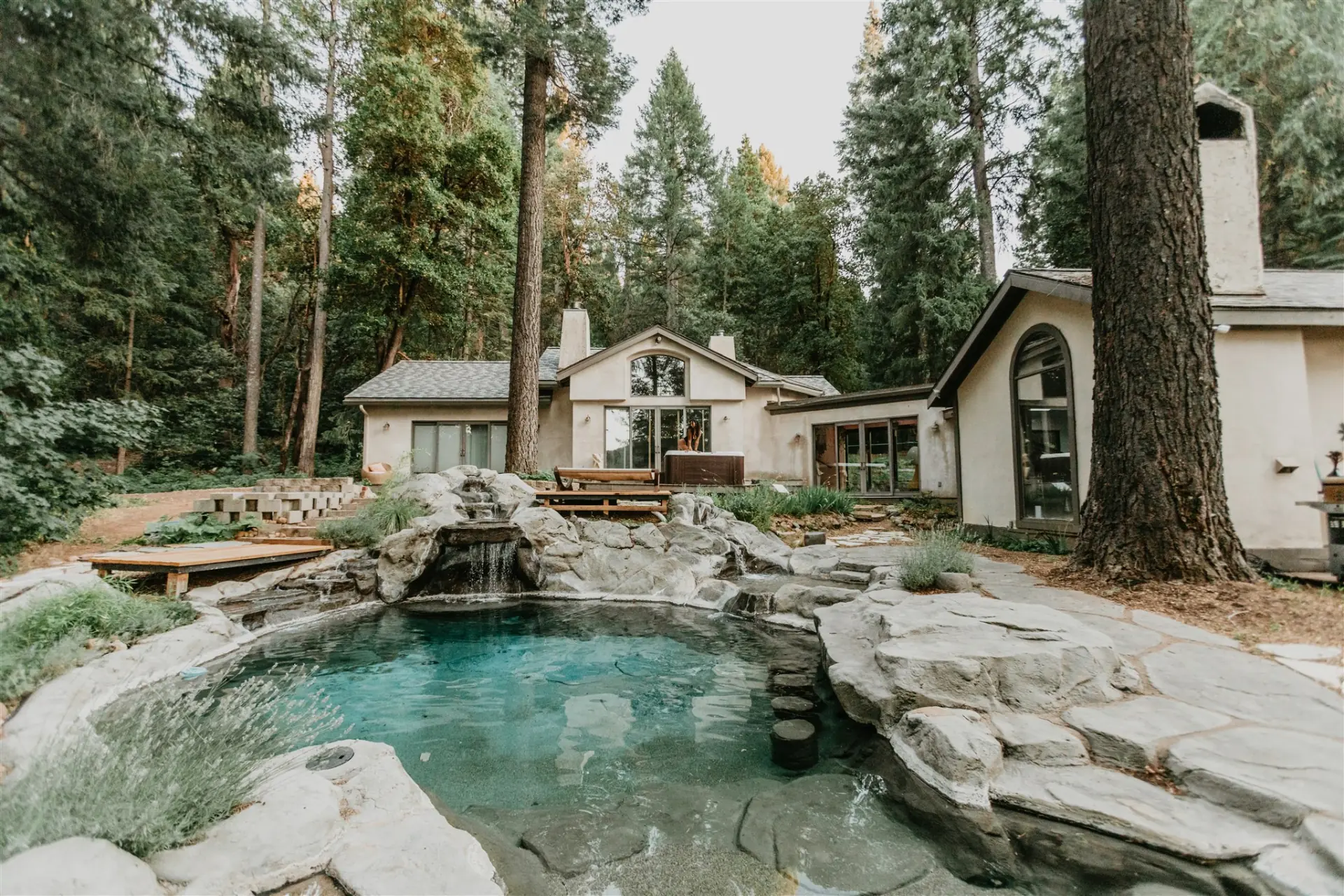 The natural rock swimming pool below the lodge, ringed by granite and tall pines