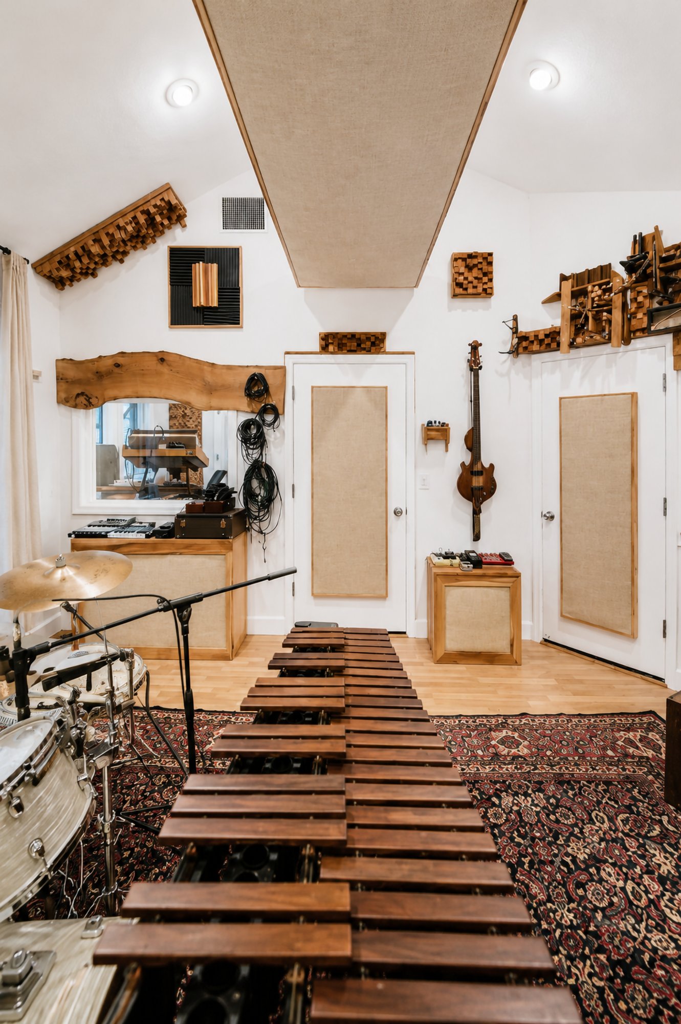 A marimba set up in the live room, drums and cymbals behind it