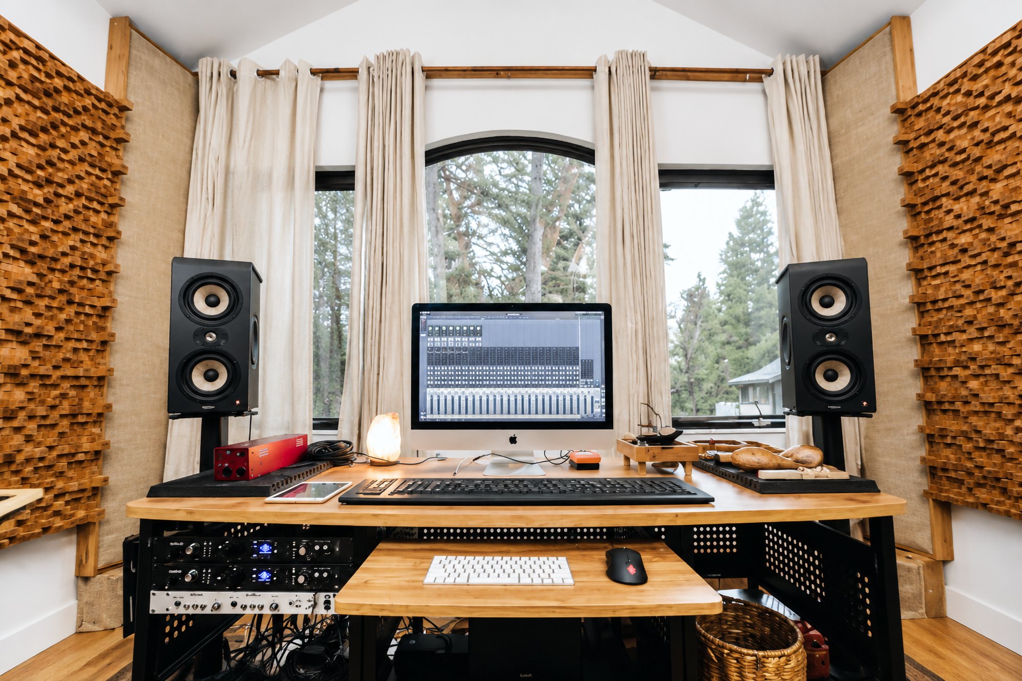 The mixing console and near-field monitors framed by the window